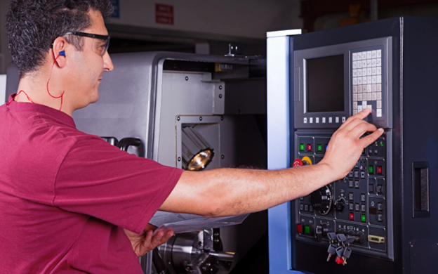 Operator calibrating HMI touchscreen on CNC machine